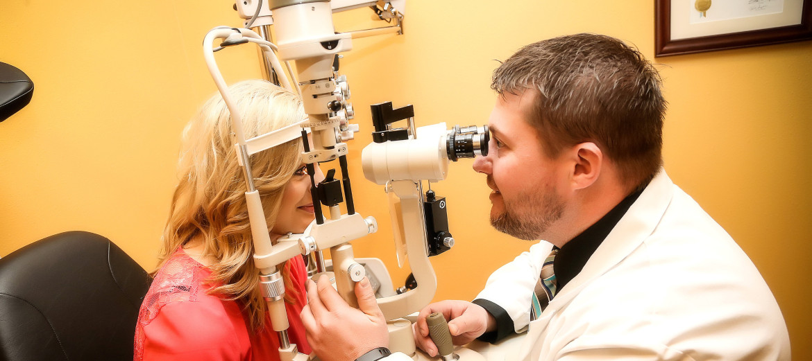 Dr. Johnson using slit lamp to look at little girl's eye